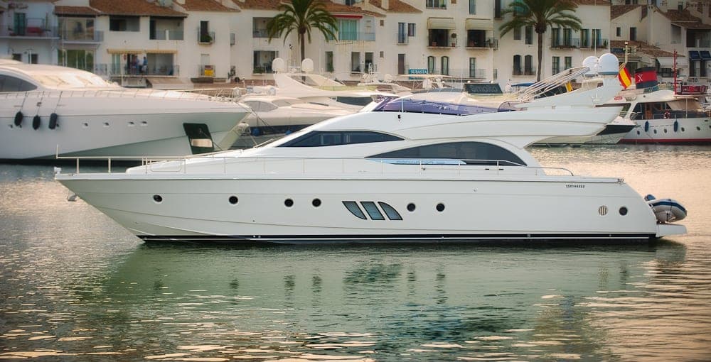 A motor yacht moored in a harbour.
